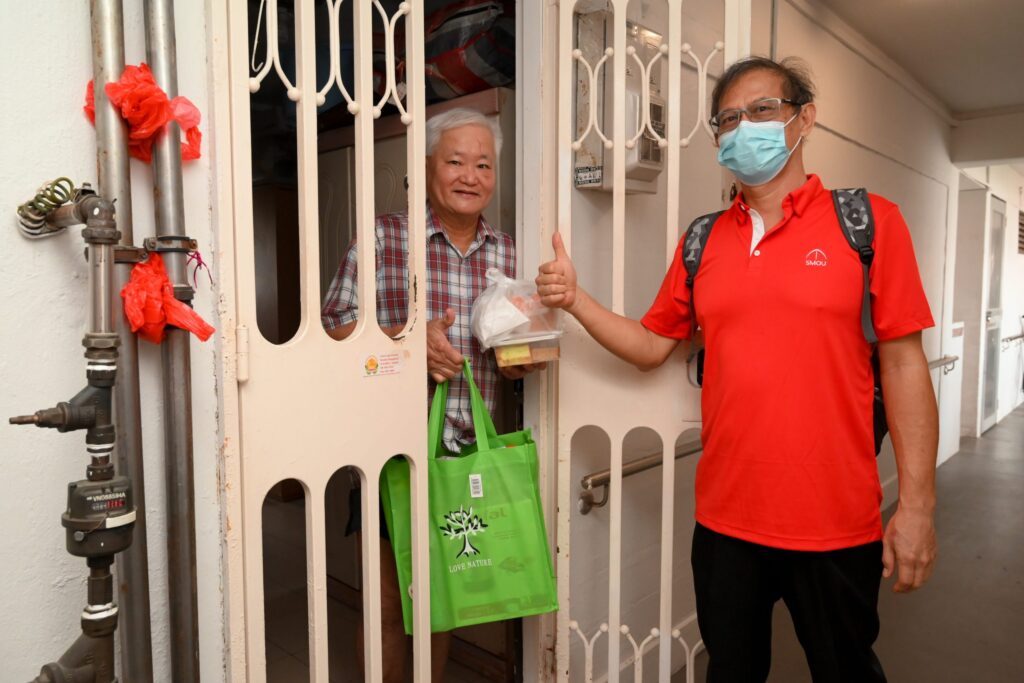Brother Cheh Yong Seng seen here giving a resident a care bag