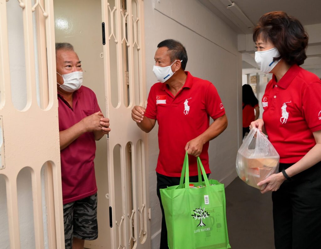 Brother Yong Soon Huat and Sister Mary Liew seen here engaging in short conversation with a resident