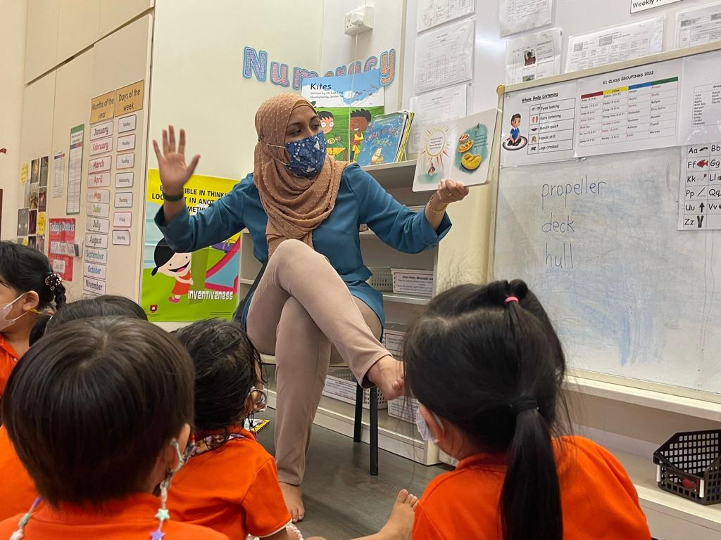 Teacher reading the maritime book to the children
