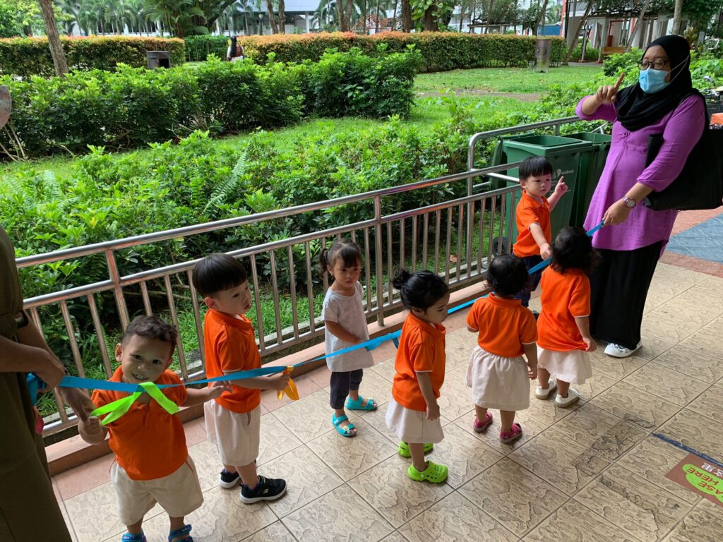 The toddlers using the walking rings for their outdoor activity.